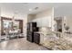 Open kitchen with island, granite countertops, and seating area at 16280 W Desert Winds Dr, Surprise, AZ 85374