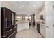 Bright kitchen with stone countertops, stainless steel appliances, and tile flooring at 16280 W Desert Winds Dr, Surprise, AZ 85374