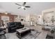 Bright living room with tile floors, ceiling fan, and modern furniture at 16280 W Desert Winds Dr, Surprise, AZ 85374