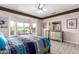 Bright main bedroom boasts large windows, neutral paint, and tiled floors at 16280 W Desert Winds Dr, Surprise, AZ 85374