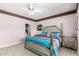 Elegant main bedroom with tile floors and stylish furniture at 16280 W Desert Winds Dr, Surprise, AZ 85374