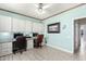 Bright office with built-in shelves, desk, and tile floor at 16280 W Desert Winds Dr, Surprise, AZ 85374