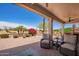 Covered patio with chairs and desert landscaping outside at 16280 W Desert Winds Dr, Surprise, AZ 85374