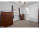 Cozy bedroom featuring neutral carpet, minimalist decor, and an adjoining bathroom for added convenience at 1654 S 77Th St, Mesa, AZ 85209