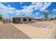 Single-story home with a covered carport and gravel landscaping offering a low-maintenance yard at 1654 S 77Th St, Mesa, AZ 85209