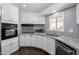 Updated kitchen with granite countertops, modern appliances, and sleek white cabinetry at 1654 S 77Th St, Mesa, AZ 85209