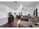 Spacious living room and dining area featuring wood-look floors and abundant natural light at 1654 S 77Th St, Mesa, AZ 85209