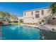 Private backyard with a sparkling pool, seating and shade at 18868 E Mockingbird Dr, Queen Creek, AZ 85142