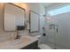 Contemporary bathroom with a glass-enclosed shower, marble countertop, and modern fixtures at 18868 E Mockingbird Dr, Queen Creek, AZ 85142