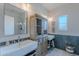 Charming bathroom featuring double sinks, herringbone floors, and a subway tile shower with great natural light at 18868 E Mockingbird Dr, Queen Creek, AZ 85142