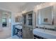 Stylish bathroom boasts dual sinks, a storage cabinet, and modern fixtures for a functional and aesthetically pleasing space at 18868 E Mockingbird Dr, Queen Creek, AZ 85142