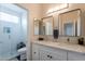 Bright bathroom featuring dual sinks, modern lighting, and a glass-enclosed shower for a spa-like experience at 18868 E Mockingbird Dr, Queen Creek, AZ 85142