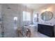 Luxurious bathroom showcasing a glass shower, soaking tub, marble tiling, and updated vanity at 18868 E Mockingbird Dr, Queen Creek, AZ 85142