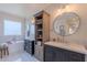 Bright bathroom with dual vanities, soaking tub, marble countertops, and classic decorative fixtures at 18868 E Mockingbird Dr, Queen Creek, AZ 85142