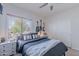 Inviting bedroom features a modern bed, window with view, and built-in storage for a clutter-free living at 18868 E Mockingbird Dr, Queen Creek, AZ 85142