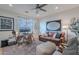Bedroom setup as home office with comfortable seating, bright windows, and neutral decor at 18868 E Mockingbird Dr, Queen Creek, AZ 85142