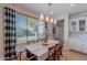 Bright dining room with wood table, natural light, and neutral walls, creating a cozy atmosphere at 18868 E Mockingbird Dr, Queen Creek, AZ 85142