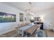 Dining area with wood table, modern lighting, and views of kitchen and art at 18868 E Mockingbird Dr, Queen Creek, AZ 85142