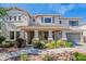 Inviting two-story home featuring a covered porch with stone accents and a well-manicured front yard at 18868 E Mockingbird Dr, Queen Creek, AZ 85142