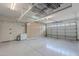 Spacious garage with built-in cabinets, overhead storage rack, and epoxy flooring at 18868 E Mockingbird Dr, Queen Creek, AZ 85142