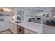 Bright kitchen with white countertops, stainless steel appliances, and an open view to the living room at 18868 E Mockingbird Dr, Queen Creek, AZ 85142