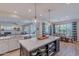 Open kitchen featuring a large island with quartz countertops, pendant lights, and stainless steel appliances at 18868 E Mockingbird Dr, Queen Creek, AZ 85142