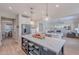 Open-concept kitchen featuring a large island, stainless steel appliances, and a seamless flow to the living area at 18868 E Mockingbird Dr, Queen Creek, AZ 85142