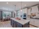 Spacious kitchen with a large center island, modern appliances, and an adjacent dining area at 18868 E Mockingbird Dr, Queen Creek, AZ 85142