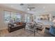 Open concept living room with view into kitchen, comfortable seating and French doors at 18868 E Mockingbird Dr, Queen Creek, AZ 85142