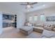 Cozy Living Room showcasing access to a study, complemented by a large sectional sofa at 18868 E Mockingbird Dr, Queen Creek, AZ 85142