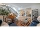 Bright living room with piano, stairs, and view into the dining room at 18868 E Mockingbird Dr, Queen Creek, AZ 85142