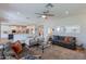 Bright and spacious living room with modern furnishings and an open floor plan adjacent to the kitchen at 18868 E Mockingbird Dr, Queen Creek, AZ 85142