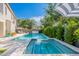 Large swimming pool and hot tub with umbrella and lounge chairs at 18868 E Mockingbird Dr, Queen Creek, AZ 85142