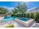 Sparkling pool and spa with well-manicured landscaping creating a serene oasis at 18868 E Mockingbird Dr, Queen Creek, AZ 85142