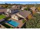 Aerial view of the home with a private backyard oasis featuring a sparkling pool and covered patio area at 20765 E Raven Dr, Queen Creek, AZ 85142