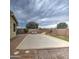Spacious backyard with covered pool, stone landscaping, brick patio, and lounge chairs with a waterfall feature at 20765 E Raven Dr, Queen Creek, AZ 85142