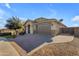 Beautiful home featuring a paver driveway, desert landscaping, and great curb appeal on a sunny day at 20765 E Raven Dr, Queen Creek, AZ 85142