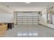 Well-lit garage with an epoxy floor and storage cabinet, offering functionality and aesthetic appeal at 20765 E Raven Dr, Queen Creek, AZ 85142