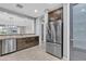 Open concept kitchen featuring stainless steel appliances and stylish cabinetry with a pantry at 20765 E Raven Dr, Queen Creek, AZ 85142