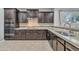 Well-equipped kitchen features stainless steel appliances, granite counters, and dark wood cabinets at 20765 E Raven Dr, Queen Creek, AZ 85142