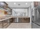 Modern kitchen with stainless steel appliances, stone countertops, and seamlessly connects to the living space at 20765 E Raven Dr, Queen Creek, AZ 85142