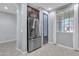 Modern kitchen featuring stainless steel refrigerator and pantry, complemented by natural light at 20765 E Raven Dr, Queen Creek, AZ 85142