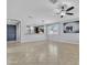 Bright living room featuring tile floors, neutral walls, and an open layout connecting to the kitchen at 20765 E Raven Dr, Queen Creek, AZ 85142