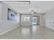 Spacious living room featuring tile flooring, a ceiling fan, neutral paint, and natural light streaming in from the backyard at 20765 E Raven Dr, Queen Creek, AZ 85142