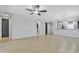 Expansive living room featuring tile flooring, a ceiling fan, neutral paint, and convenient access to adjacent spaces at 20765 E Raven Dr, Queen Creek, AZ 85142