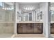 This main bathroom features a double vanity with granite countertops and a tiled shower at 20765 E Raven Dr, Queen Creek, AZ 85142