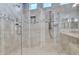 This walk-in shower features tile surround, two shower heads, and bench seating at 20765 E Raven Dr, Queen Creek, AZ 85142