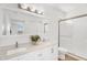 Bright bathroom featuring double sinks, quartz countertop, and a glass-enclosed shower at 20801 N 90Th Pl # 271, Scottsdale, AZ 85255
