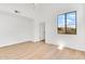 Bright bedroom with neutral walls, wood-look floors and a large window offering scenic views at 20801 N 90Th Pl # 271, Scottsdale, AZ 85255