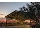 Community entrance is decorated with lights at sunset, offering an inviting ambiance at 20801 N 90Th Pl # 271, Scottsdale, AZ 85255